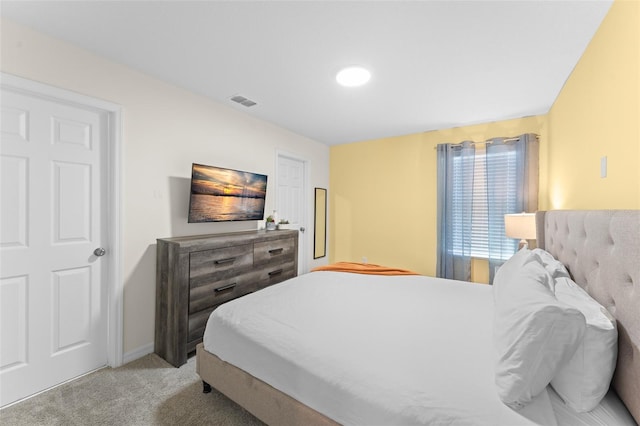 bedroom featuring visible vents and light carpet