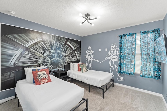 bedroom featuring baseboards, carpet flooring, and a textured ceiling