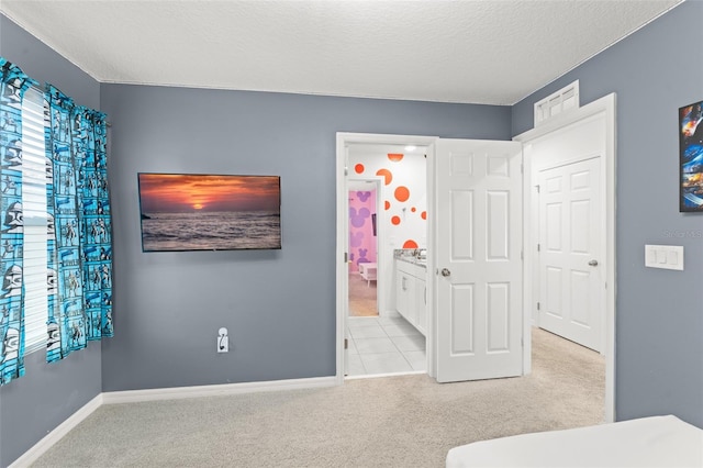 unfurnished bedroom featuring baseboards, carpet flooring, and a textured ceiling