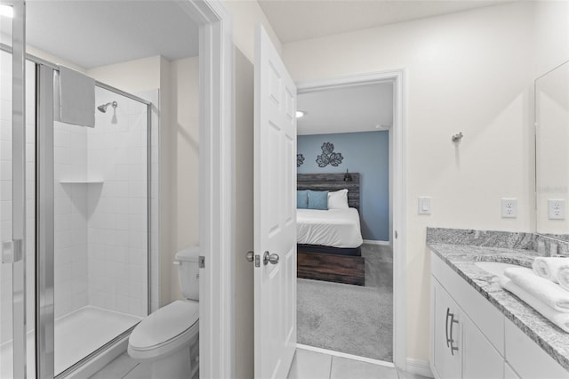 full bathroom with tile patterned flooring, a stall shower, vanity, toilet, and ensuite bath