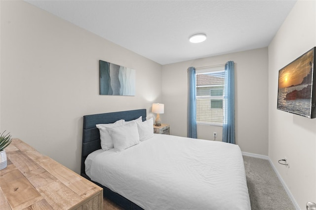 carpeted bedroom featuring baseboards