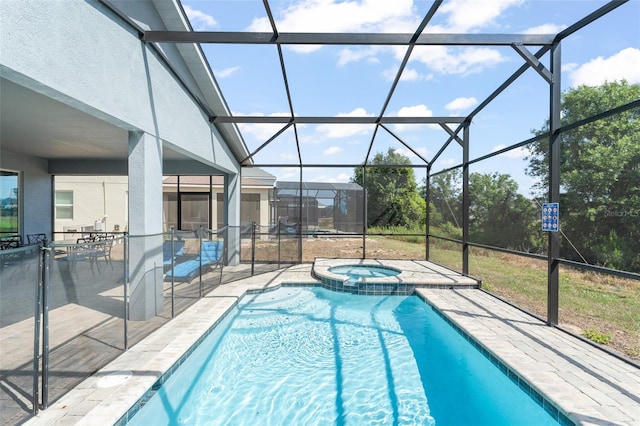 view of pool with a patio, a pool with connected hot tub, and a lanai