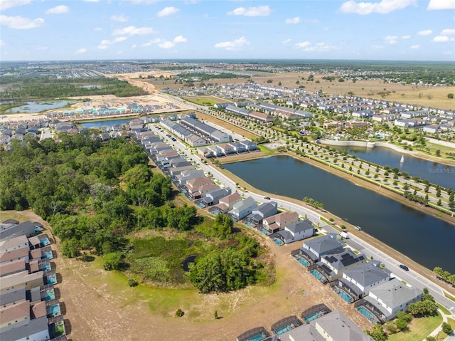 birds eye view of property with a water view and a residential view