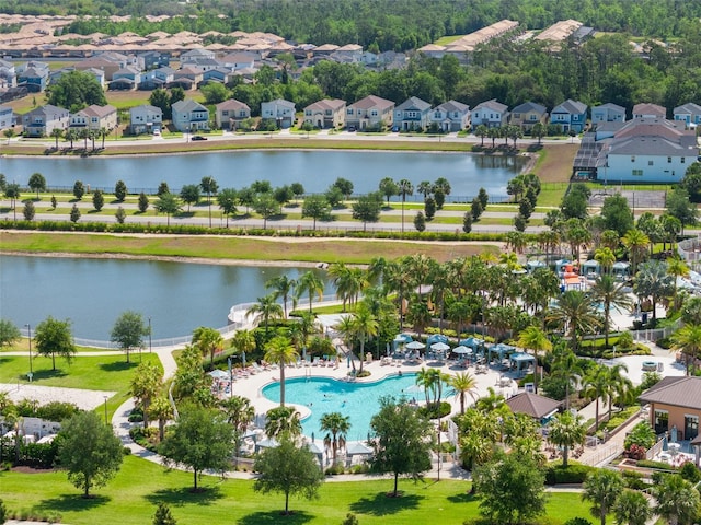 drone / aerial view with a water view and a residential view
