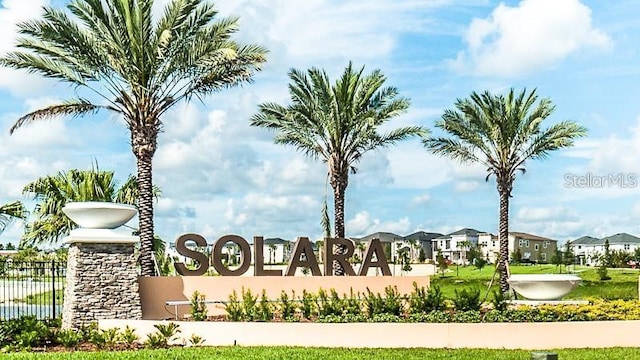 community / neighborhood sign with fence and a residential view