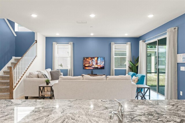 2009 Tropical Palms Cir, Kissimmee, FL 34747 - living room featuring recessed lighting and stairs