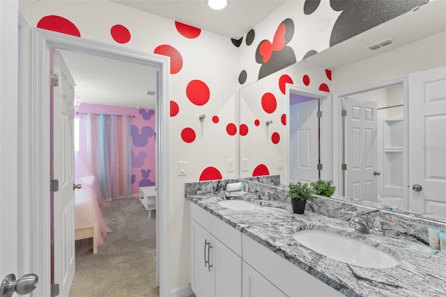 2009 Tropical Palms Cir, Kissimmee, FL 34747 - full bathroom featuring double vanity, ensuite bath, and baseboards