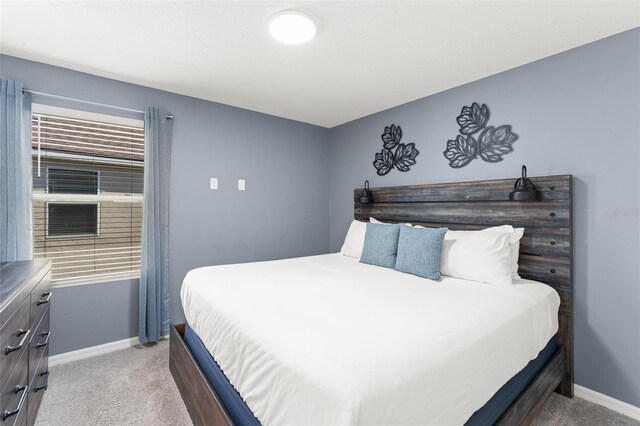 2009 Tropical Palms Cir, Kissimmee, FL 34747 - bedroom featuring light carpet and baseboards