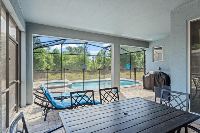 2009 Tropical Palms Cir, Kissimmee, FL 34747 - sunroom with a hot tub, outdoor dining area, plenty of natural light, and a pool