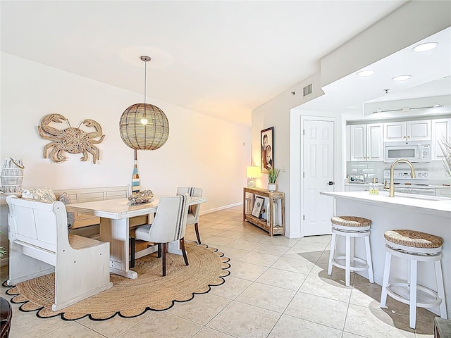 5300 S Atlantic Ave Unit 9-302, New Smyrna Beach, FL 32169 - dining room featuring vaulted ceiling, visible vents, recessed lighting, and light tile patterned floors