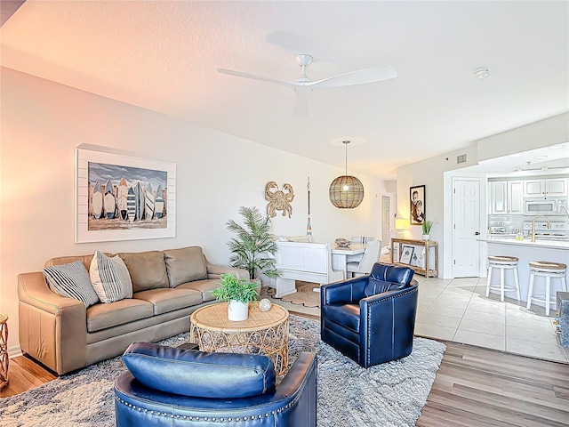 5300 S Atlantic Ave Unit 9-302, New Smyrna Beach, FL 32169 - living room with a ceiling fan and light wood-style flooring