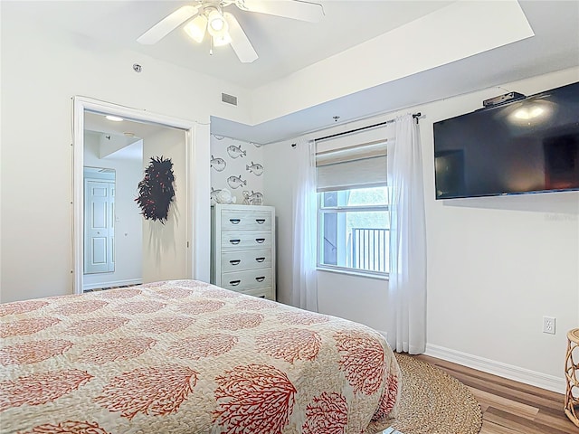 5300 S Atlantic Ave Unit 9-302, New Smyrna Beach, FL 32169 - bedroom with ceiling fan, baseboards, wood finished floors, and visible vents