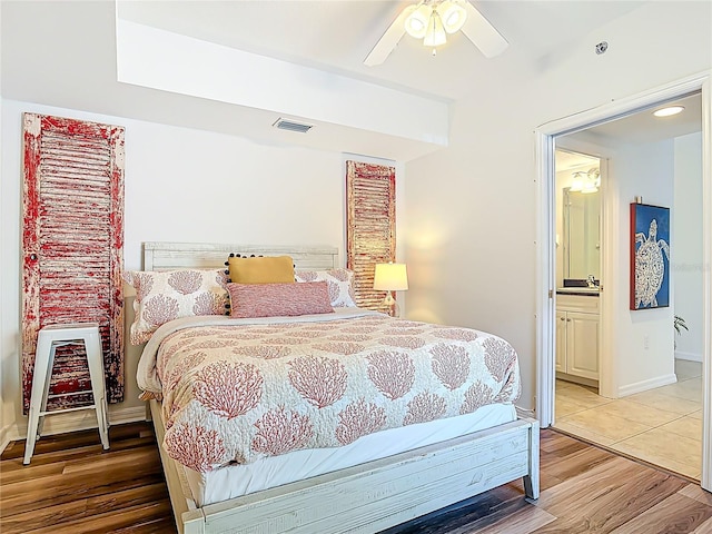 5300 S Atlantic Ave Unit 9-302, New Smyrna Beach, FL 32169 - bedroom with light wood-type flooring, ceiling fan, baseboards, ensuite bath, and visible vents
