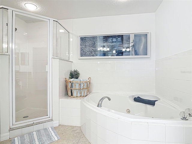 5300 S Atlantic Ave Unit 9-302, New Smyrna Beach, FL 32169 - bathroom featuring a stall shower, tile patterned flooring, and a tub with jets