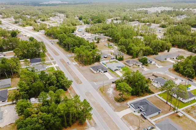 bird's eye view featuring a view of trees and a residential view