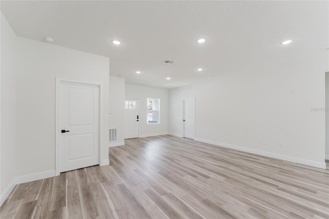 interior space featuring recessed lighting, visible vents, light wood-style flooring, and baseboards