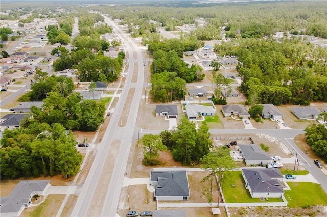 drone / aerial view with a residential view and a wooded view