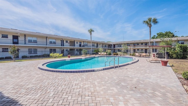 pool featuring a patio and fence