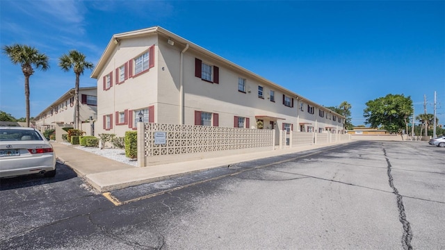 view of property with uncovered parking