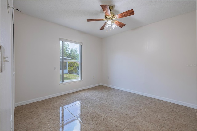 50989 Hwy 27 Unit 371, Davenport, FL 33897 - unfurnished room featuring baseboards, light tile patterned floors, a textured ceiling, and a ceiling fan