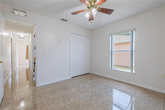 50989 Hwy 27 Unit 371, Davenport, FL 33897 - unfurnished bedroom featuring baseboards, a closet, a ceiling fan, and light tile patterned flooring