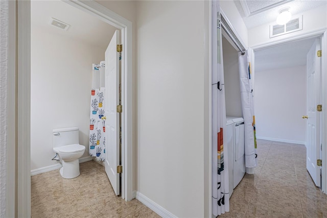 50989 Hwy 27 Unit 371, Davenport, FL 33897 - hallway featuring light tile patterned floors, washer and dryer, and baseboards