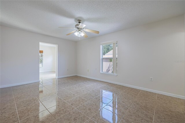 50989 Hwy 27 Unit 371, Davenport, FL 33897 - spare room with ceiling fan, tile patterned flooring, a textured ceiling, and baseboards