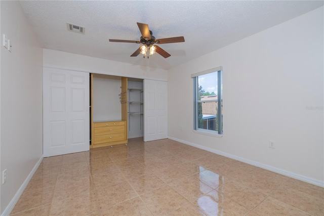 50989 Hwy 27 Unit 371, Davenport, FL 33897 - unfurnished bedroom with a closet, light tile patterned flooring, a textured ceiling, baseboards, and ceiling fan