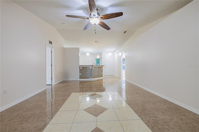 50989 Hwy 27 Unit 371, Davenport, FL 33897 - spare room featuring vaulted ceiling, light tile patterned floors, a ceiling fan, baseboards, and arched walkways