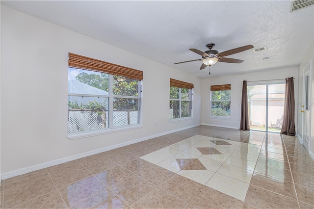 50989 Hwy 27 Unit 371, Davenport, FL 33897 - unfurnished room with light tile patterned flooring, baseboards, a ceiling fan, and a textured ceiling