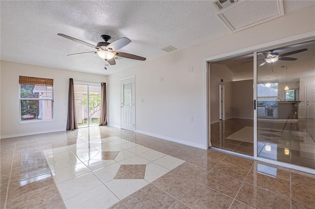 50989 Hwy 27 Unit 371, Davenport, FL 33897 - empty room with a ceiling fan, light tile patterned floors, baseboards, and a textured ceiling