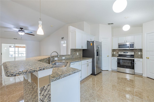 50989 Hwy 27 Unit 371, Davenport, FL 33897 - kitchen with appliances with stainless steel finishes, a peninsula, a sink, light tile patterned floors, and decorative backsplash