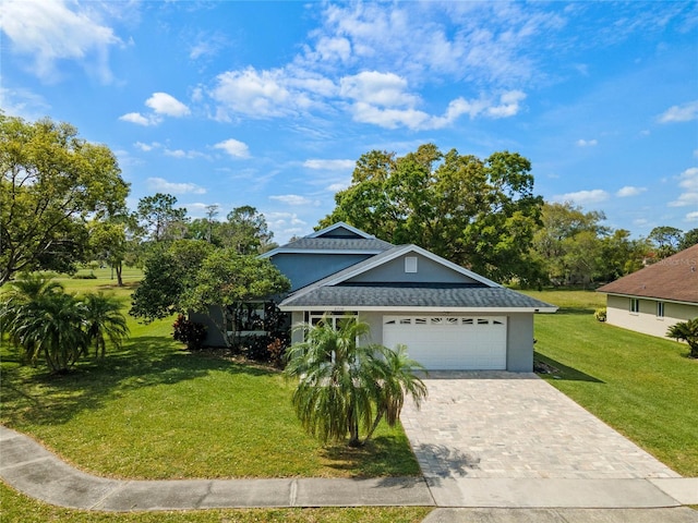 2710 Alabaster Ave, Orlando, FL 32833 - view of front of property with decorative driveway, a front lawn, a shingled roof, an attached garage, and stucco siding