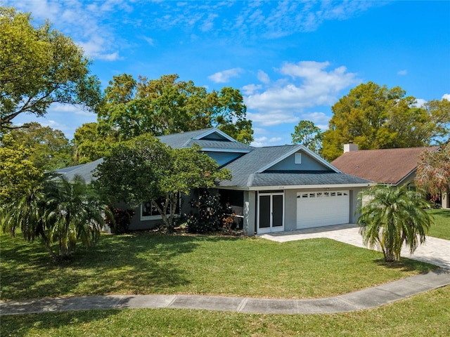 2710 Alabaster Ave, Orlando, FL 32833 - view of front of property featuring a garage, driveway, a shingled roof, a front yard, and stucco siding