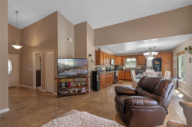 2710 Alabaster Ave, Orlando, FL 32833 - living area with high vaulted ceiling, visible vents, baseboards, and an inviting chandelier