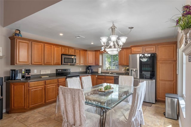 2710 Alabaster Ave, Orlando, FL 32833 - kitchen featuring a sink, brown cabinetry, a chandelier, stainless steel appliances, and recessed lighting