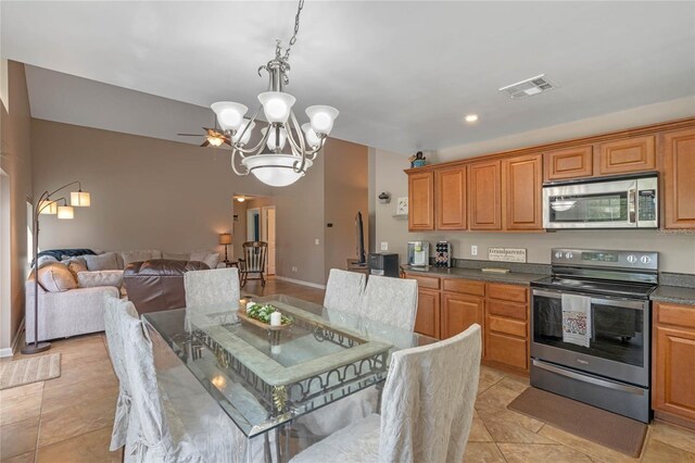 2710 Alabaster Ave, Orlando, FL 32833 - kitchen featuring dark countertops, open floor plan, an inviting chandelier, appliances with stainless steel finishes, and visible vents