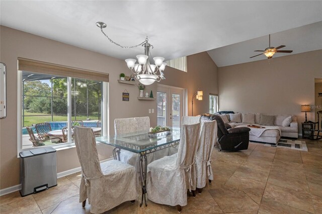 2710 Alabaster Ave, Orlando, FL 32833 - dining space featuring french doors, baseboards, lofted ceiling, ceiling fan with notable chandelier, and light tile patterned floors