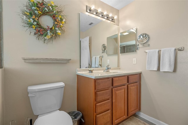 2710 Alabaster Ave, Orlando, FL 32833 - bathroom with toilet, vanity, visible vents, and baseboards