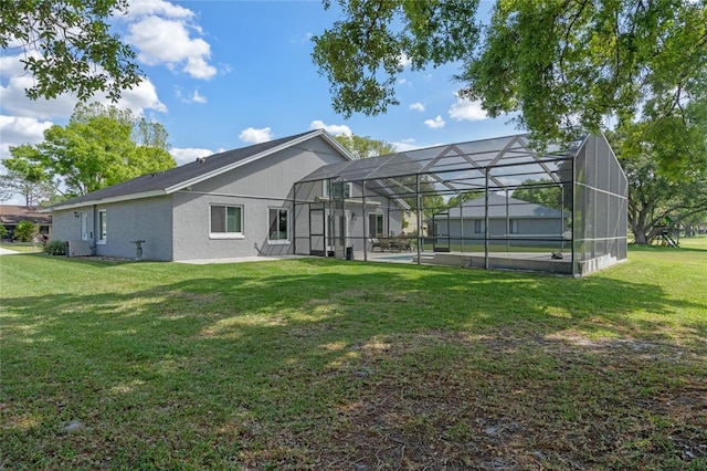2710 Alabaster Ave, Orlando, FL 32833 - rear view of house featuring a lawn, glass enclosure, and stucco siding