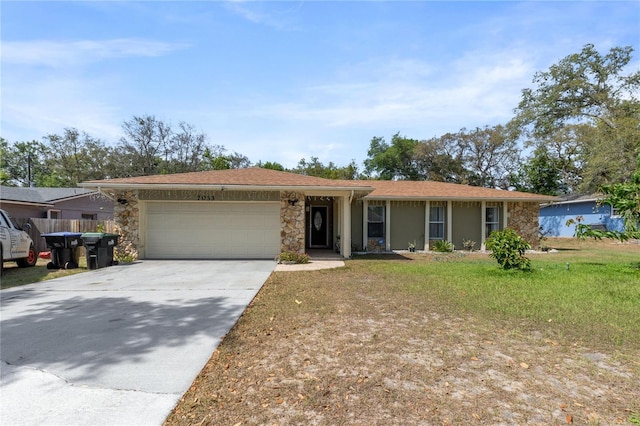 ranch-style home featuring a garage, driveway, stone siding, a front yard, and stucco siding