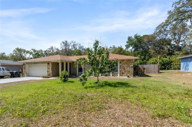 ranch-style house featuring fence, concrete driveway, stone siding, a front yard, and a garage