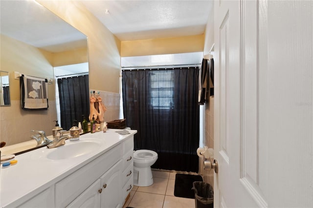 full bathroom featuring tile patterned floors, a shower with curtain, toilet, tile walls, and vanity