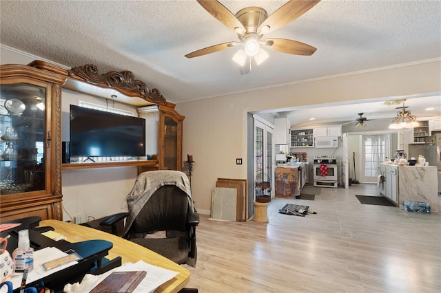 interior space featuring light wood-style floors, crown molding, baseboards, a textured ceiling, and ceiling fan