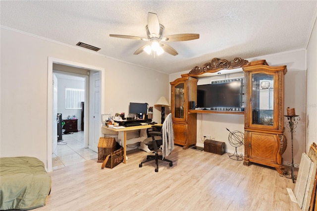 office featuring ceiling fan, wood finished floors, visible vents, and a textured ceiling