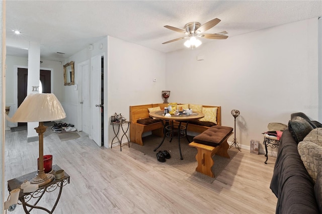 dining room featuring light wood-style flooring, baseboards, breakfast area, and ceiling fan