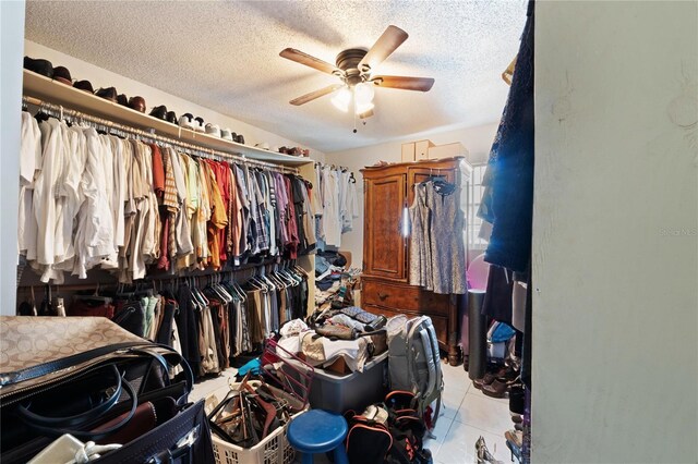 walk in closet with ceiling fan and light tile patterned floors