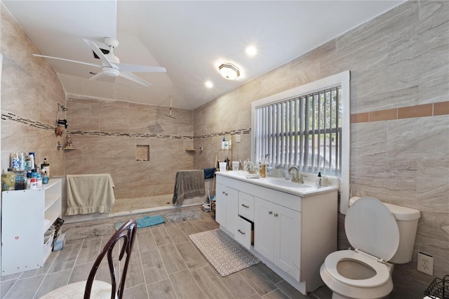 full bath with tile walls, lofted ceiling, a ceiling fan, walk in shower, and vanity