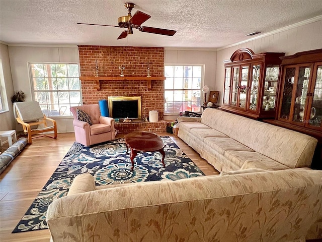 76 Oakdale St, Windermere, FL 34786 - living area with a textured ceiling, wood finished floors, a ceiling fan, and a brick fireplace