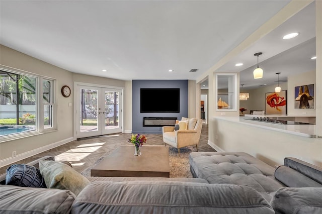 1003 Shore Dr, Kissimmee, FL 34744 - living room with baseboards, plenty of natural light, visible vents, and french doors